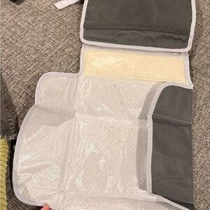 Munchkin GoChange Gray Changing Pad and wipes clutch.